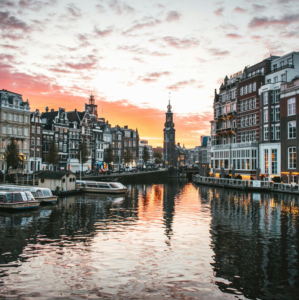 Picturesque scene of buildings and boats along a canal in Amersterdam
